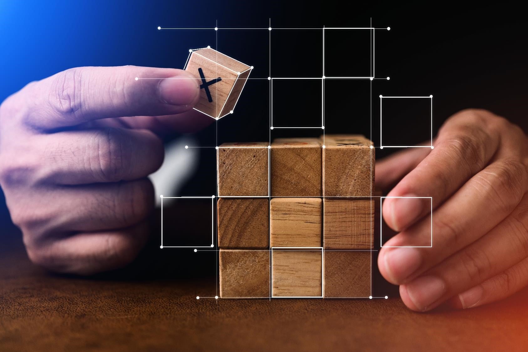 Concept of a businessman trying to rearrange the blocks of an organization.